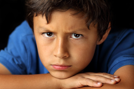 Portrait of young school boy with chiaroscuro lighting - shallow depth of field