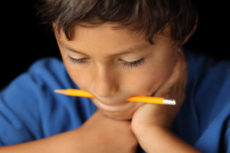 Portrait of young school boy with chiaroscuro lighting - shallow depth of fieldの写真素材