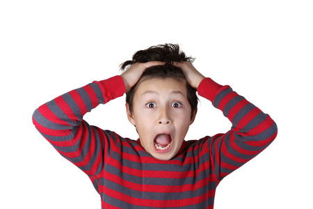 Young boy with shocked expression on white isolated backgroundの写真素材