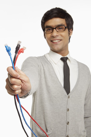  Man holding up three network connection cablesの写真素材