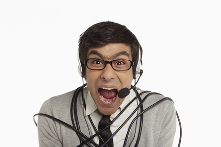 Man with headset wrapped in a tangled cable