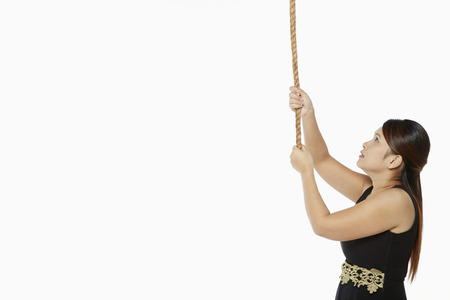 Woman holding on to a ropeの写真素材
