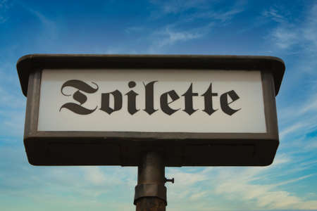 Antique Toilet Sign "Toilette" Shows The Way to the Restroomの写真素材