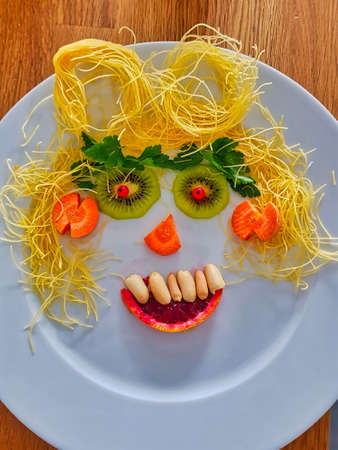 Vegetable face on a white plateの写真素材