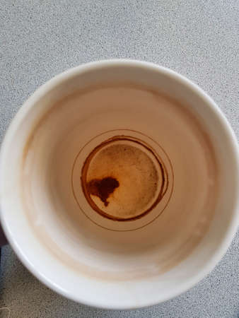 an empty coffee cup with heart in bottom