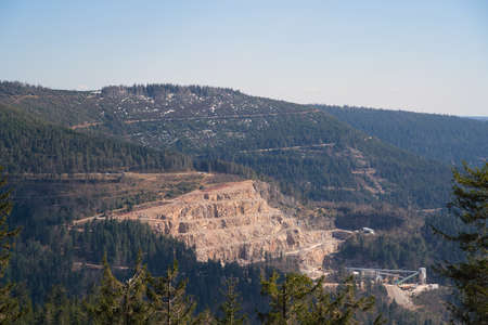 A view of a quarry from a mountain and blue sky