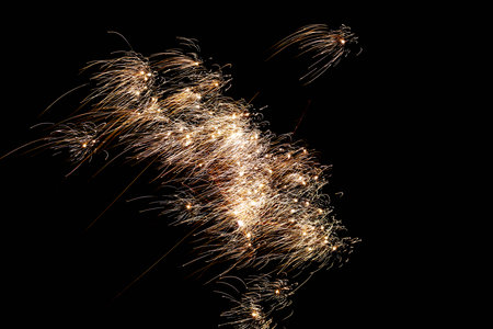Detailed macro shot capturing shimmering golden confetti at celebration