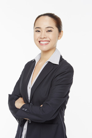 Businesswoman with arms crossed, smilingの写真素材