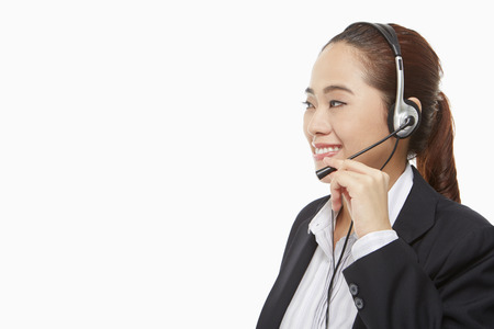Smiling businesswoman with headsetの写真素材