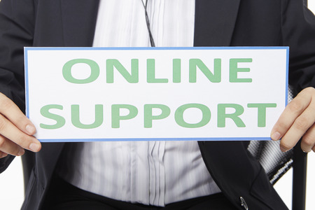 Businesswoman holding up an Online Support" sign"の写真素材