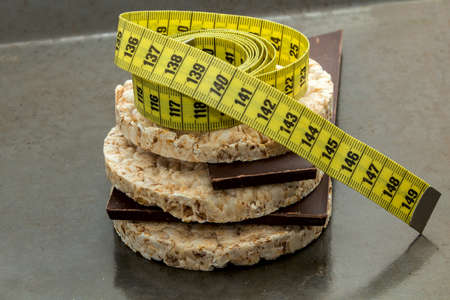 rice cake (wafers); expansion of the pyramid; dark chocolate and yellow centimeter, blurred and dark backgroundの写真素材