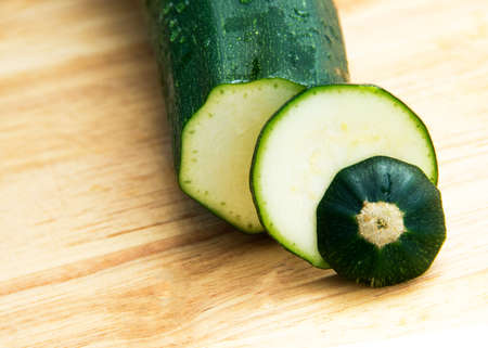 Cut zucchini on a wooden board, cut into circlesの写真素材
