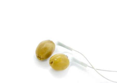 green olives wearing headphones, white background; isolatedの写真素材