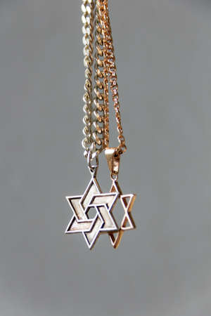 two chains, a gold six-cornered star, another silver with the trailer of Star of Davidの写真素材
