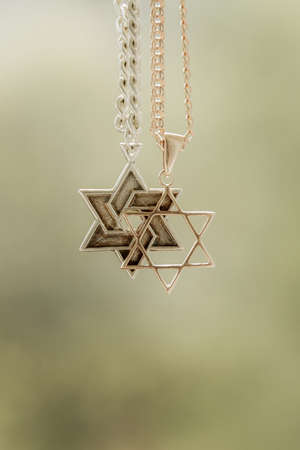 two chains, a gold six-cornered star, another silver with the trailer of Star of Davidの写真素材