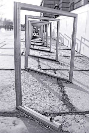 Iron Pipe, bent in the shape of the passage, the labyrinth, on the stone floor on the street, a...