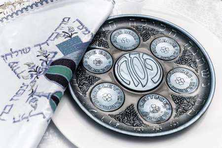 seder plate vor passover holiday, and special napkin with embroidery for matze bread, knew plate located belowのeditorial素材