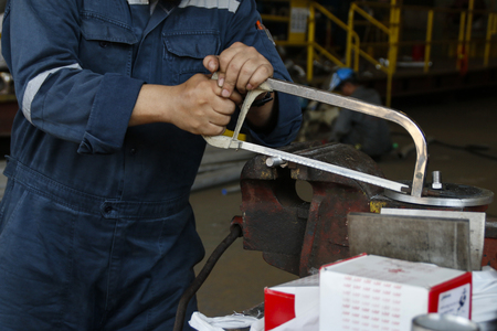engineer using metal saw cutting the screw. this scene is movement it look like blurの写真素材