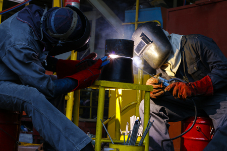 welder man are welding reduce pipeの写真素材