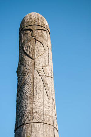 Wooden idol Slavic god Perun on a background of blue skyのeditorial素材
