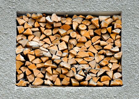 abstract background with stacked firewood in the wall