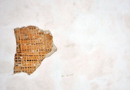 wooden wall with destroyed plaster