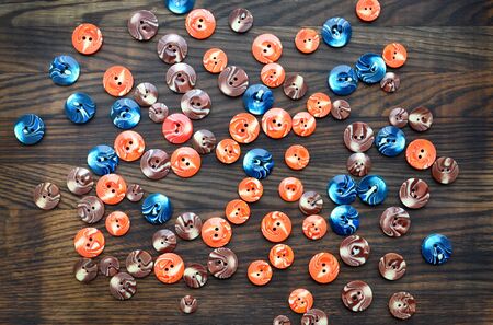 Background with buttons on wooden board. Top view