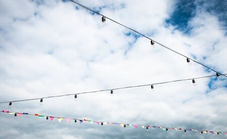 light bulbs and flags on sky background for your designの写真素材