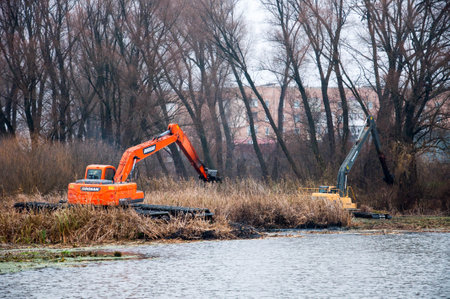 Pryluky, Chernihiv, Ukraine - 11/19/2020: Amphibious Excavators. River Cleaning. Quality image for your projectのeditorial素材