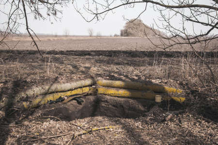 Kyiv, Ukraine - 03/23/2022: Trench in the ground under the trees for Ukrainian soldier of territorial defense position during the Russian-Ukrainian warのeditorial素材