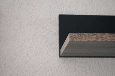 A wooden shelf on a white plastered wall. Space for inscription. Quality image for your projectの写真素材