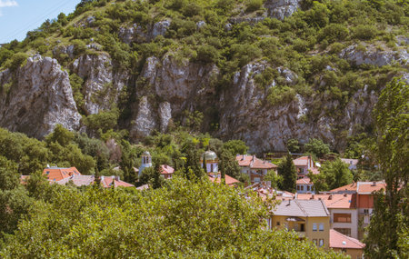 Asenovgrad, Plovdiv / Bulgaria â 07/24/2022: View of the city from above. Houses on the background of the mountain. Quality image for your projectのeditorial素材