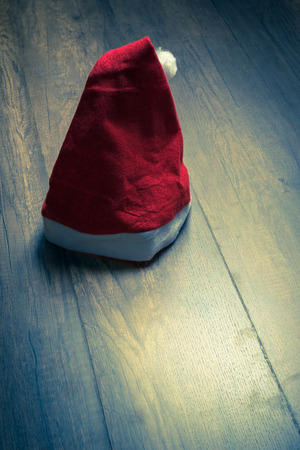 Santa red hat on wooden floor background, holiday Christmas abstract background.の写真素材