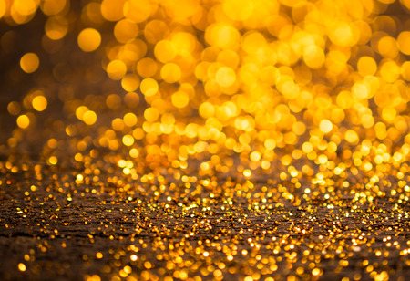 glitter vintage lights background. dark gold and black. defocusedの写真素材