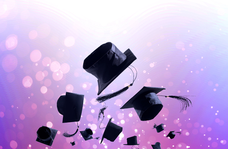 Graduation Ceremony, Graduation Caps, hat Thrown in the Air with light abstract background.の写真素材