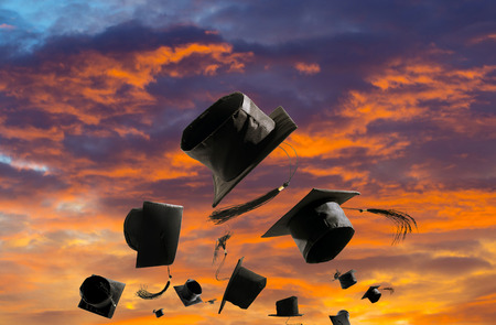 Graduation Ceremony, Graduation Caps, hat Thrown in the Air sunset sky abstract backgrpund.の写真素材
