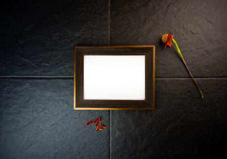 picture frame on black stone wall