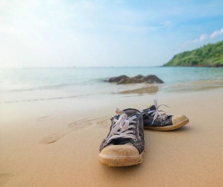 canvas shoes on sand beachの写真素材