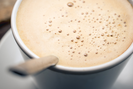 close up cup of cappuccino on the retro wooden table, cappuccino foam background.の写真素材
