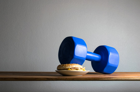 dumbbell put on hamburger idea Exercises For Weight Loss diet concept.の写真素材