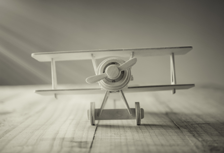 wood toy airplane on wood table in vintage tone.の写真素材