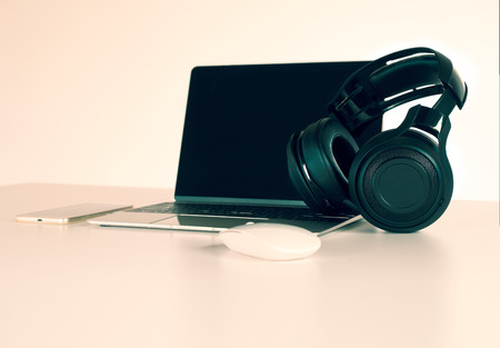 Headphones black, smartphone and laptop on Work Desk.の写真素材
