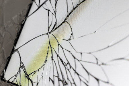 Close up broken mobile phone screen opn white background.の写真素材