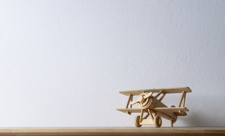 wood toy airplane on wood table.の写真素材