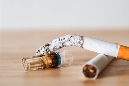 Cigarette holder filter reduce tar on wood desk.