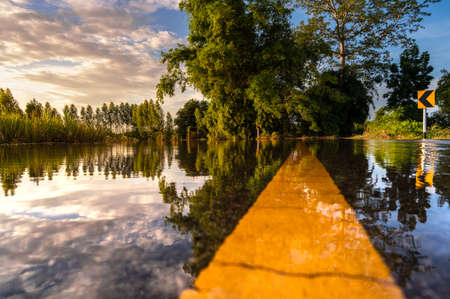 a view from a low vantage point on a flooded roadの写真素材