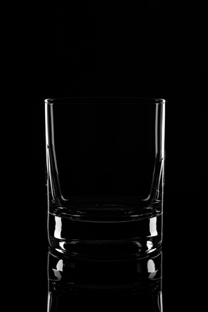 Empty glass, isolated on a black background.の写真素材
