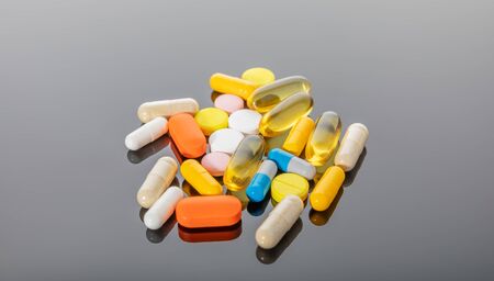 Differents pills isolated on dark background.の写真素材