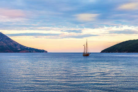 Lonely ship in the harbour of Budva, Montenegro, sunset viewの写真素材