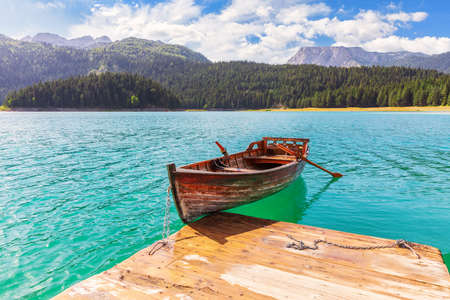 Lonely boat in the Black Lake of the Durmitor area in Montenegroの写真素材